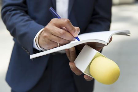 close-up-interviewee-taking-notes